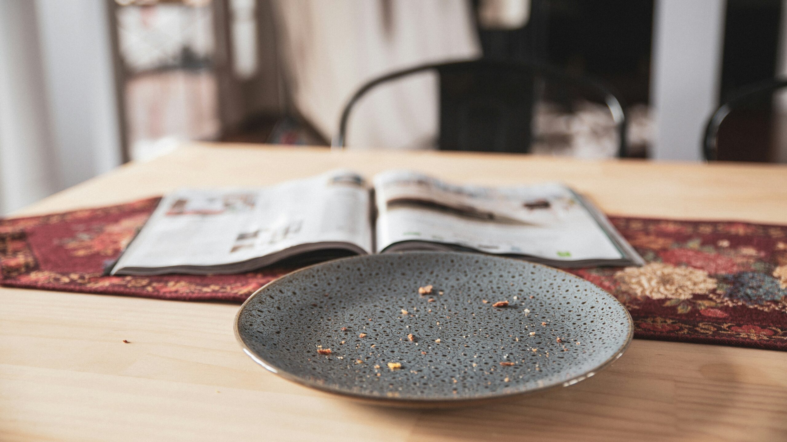 A plate with crumbs left out, a common attractor of pests in a home